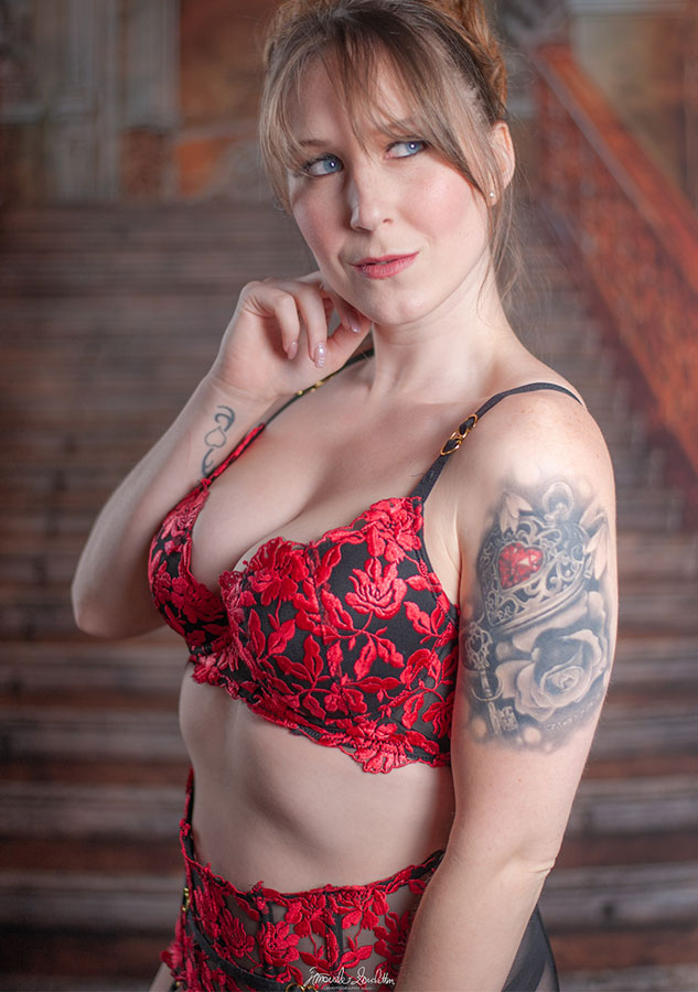 Portrait in red floral lingerie against a wooden background