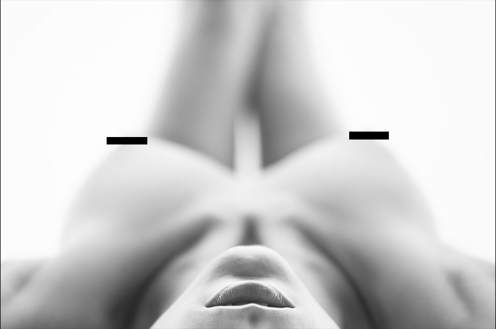 High-key reclining nude study viewed from head level