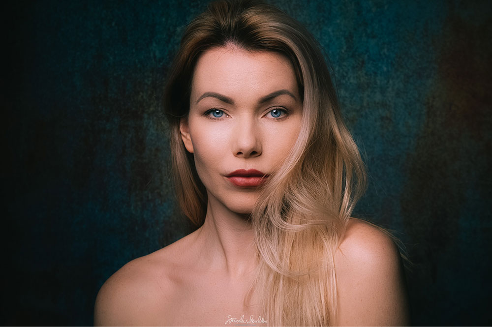 Close portrait against a textured blue and brown background