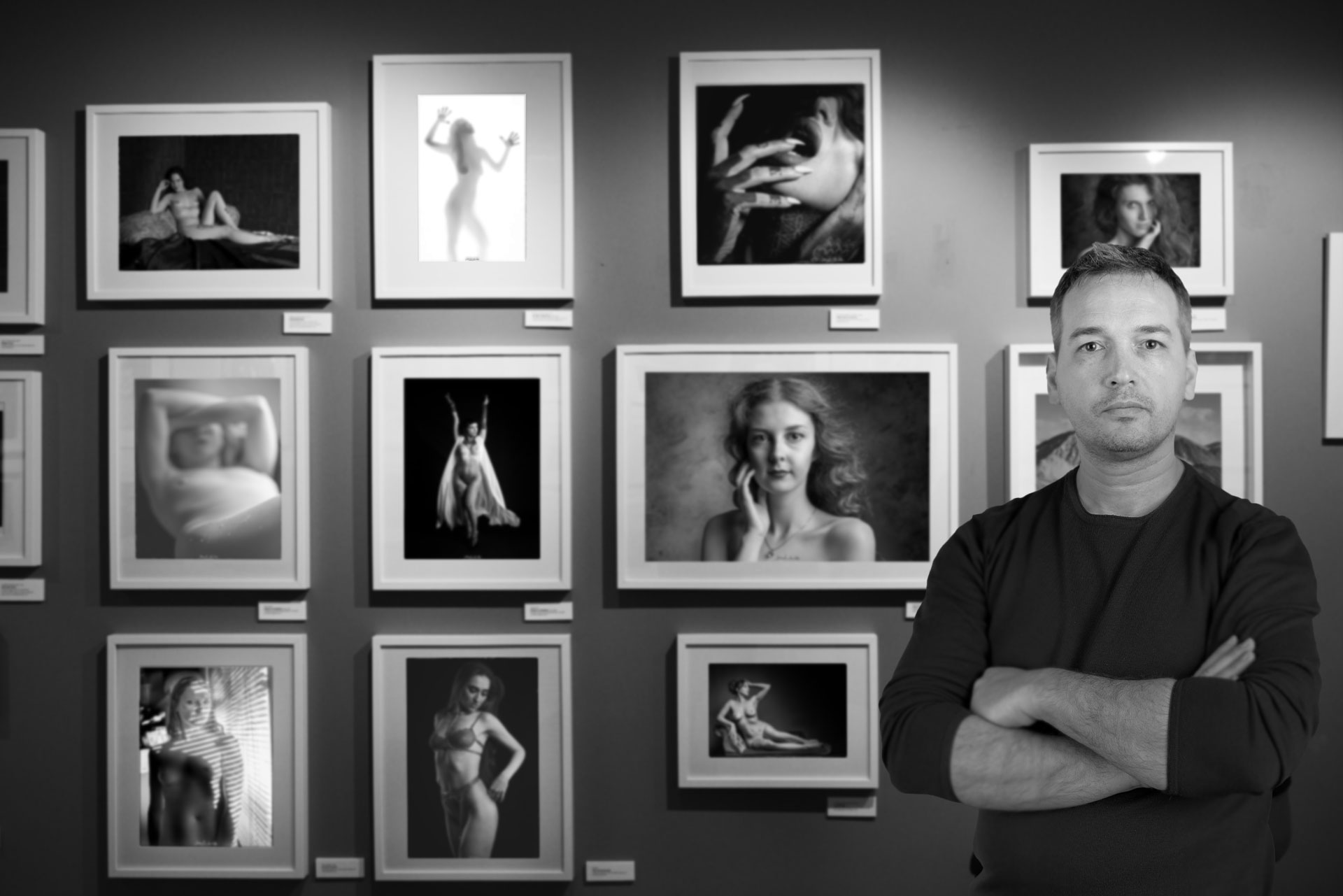 Emanuele Zanchettin, photographer behind Natural Beauty Photo, in front of a display of portrait work